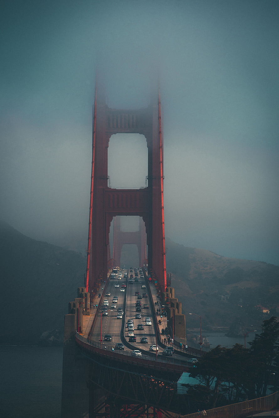 Golden Gate Bridge Tower Rising Through Thick Fog With Busy Traffic Flow HD phone wallpaper