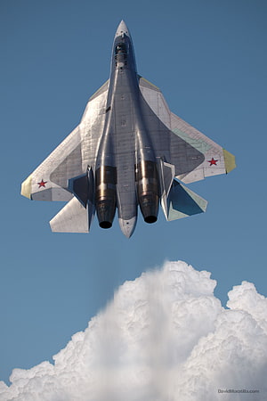 Sukhoi Su-57 Stealth Fighter Jet Flying Above Clouds in Clear Blue Sky HD phone wallpaper