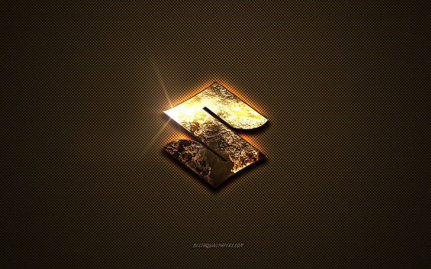 Gleaming Golden Suzuki Emblem on Dark Textured Metal Surface HD wallpaper