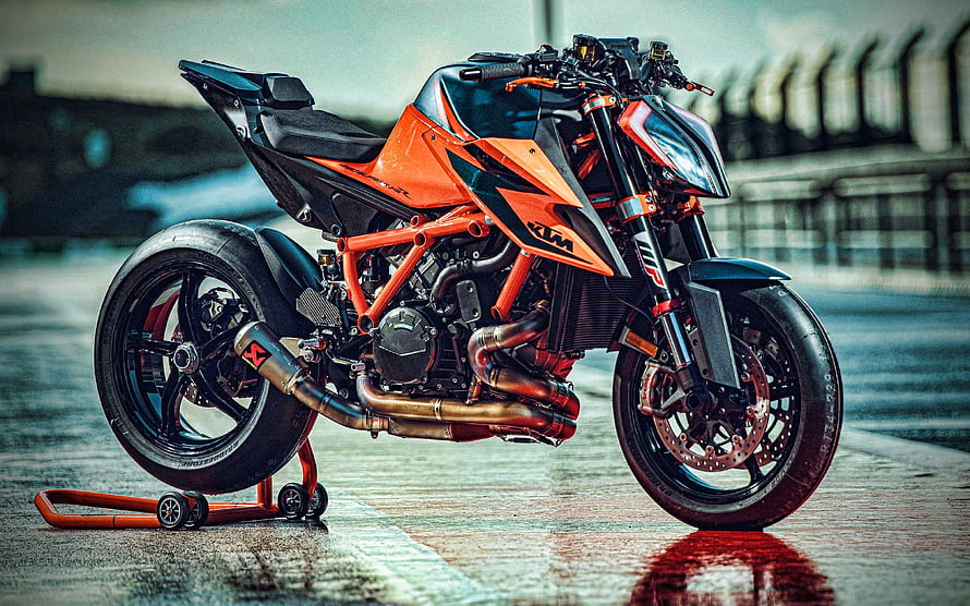 KTM 1290 Super Duke R Orange Naked Motorcycle on Wet Raceway Track HD wallpaper