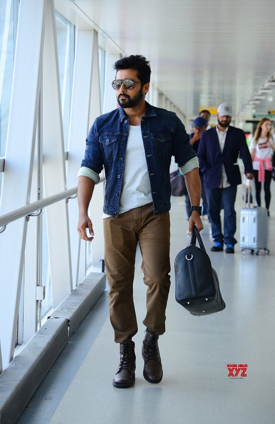 Suriya in Denim Jacket and Brown Trousers Walking Through Airport Terminal HD phone wallpaper