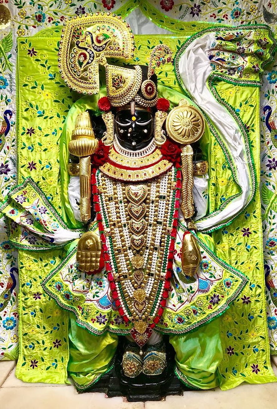 Ornate Black Idol of Lord Jagannath Adorned in Green Silk and Gold Jewelry HD phone wallpaper