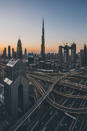 Dubai Skyline at Dawn Featuring Burj Khalifa and Sheikh Zayed Road Interchange HD phone wallpaper