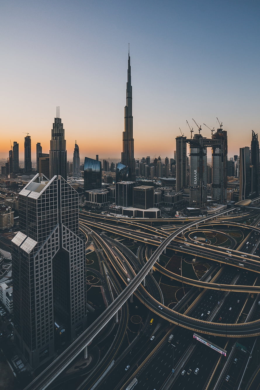 Dubai Skyline at Dawn Featuring Burj Khalifa and Sheikh Zayed Road Interchange HD phone wallpaper
