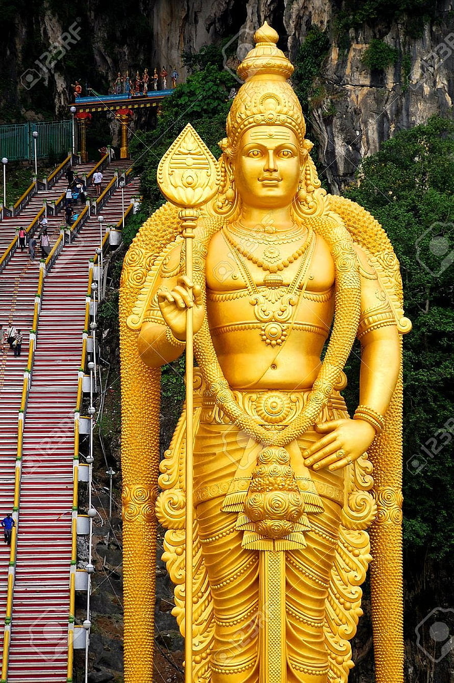 Golden Murugan Statue at Batu Caves Temple with Red Staircase and Limestone Cliffs HD phone wallpaper
