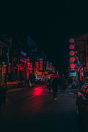 Neon-lit Chinese street at night with glowing red lanterns and signs HD phone wallpaper
