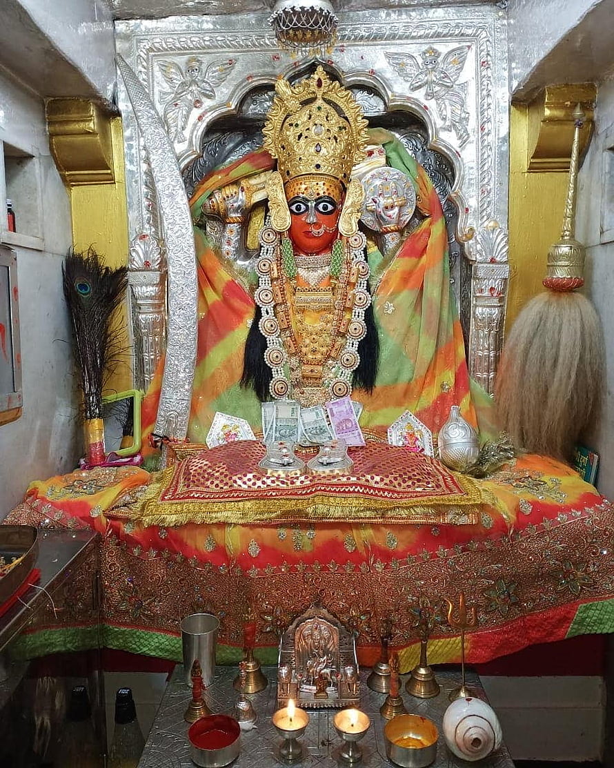 Ornate Hindu Goddess Statue in Temple Shrine with Offerings HD phone wallpaper