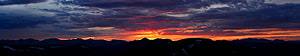 Dramatic Sunset Over Mountain Range With Fiery Orange And Purple Clouds HD wallpaper