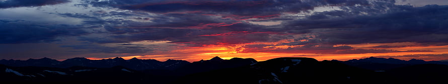 Dramatic Sunset Over Mountain Range With Fiery Orange And Purple Clouds HD wallpaper