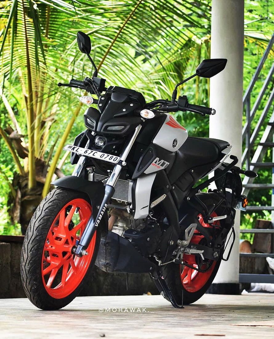 Yamaha MT-15 Motorcycle with Red Rims Parked in Tropical Garden Setting HD phone wallpaper