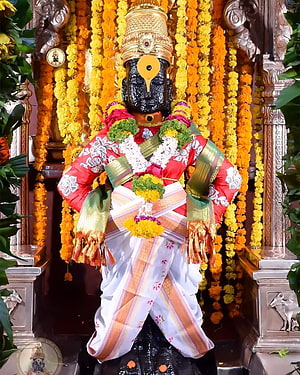 Decorated Ayyappan Statue in Temple with Marigold Garlands and Traditional Attire HD phone wallpaper