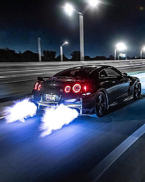 Black Nissan GT-R R35 Launching With Blue Underglow Flames At Night HD phone wallpaper