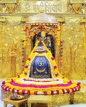 Golden Shiva Lingam Temple Decorated With Marigold Garlands And Om Symbol HD phone wallpaper