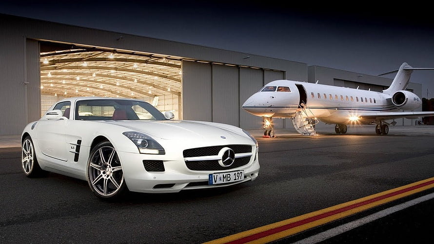 White Mercedes-Benz SLS AMG and Private Jet at Hangar at Night HD wallpaper