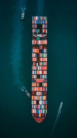 Aerial View of Massive Cargo Ship Loaded with Colorful Shipping Containers on Deep Blue Ocean HD phone wallpaper