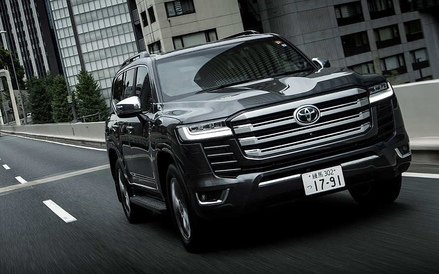 Black Toyota Land Cruiser 300 Series Driving on City Highway HD wallpaper