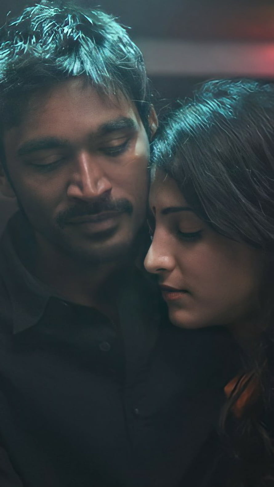 Dhanush and Actress in Intimate Romantic Embrace with Moody Cinematic Lighting HD phone wallpaper