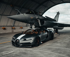 Matte Black Bugatti Chiron Super Sport 300+ Parked Under Military Jet in Hangar HD wallpaper