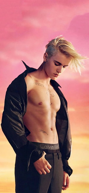 Justin Bieber shirtless portrait with black jacket against a pink sunset sky HD phone wallpaper