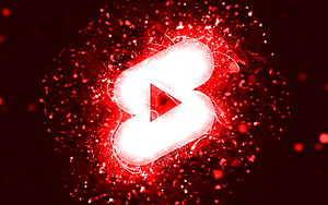 Glowing White Bluetooth Symbol Surrounded by Red Sparkles and Particles on Dark Background HD wallpaper