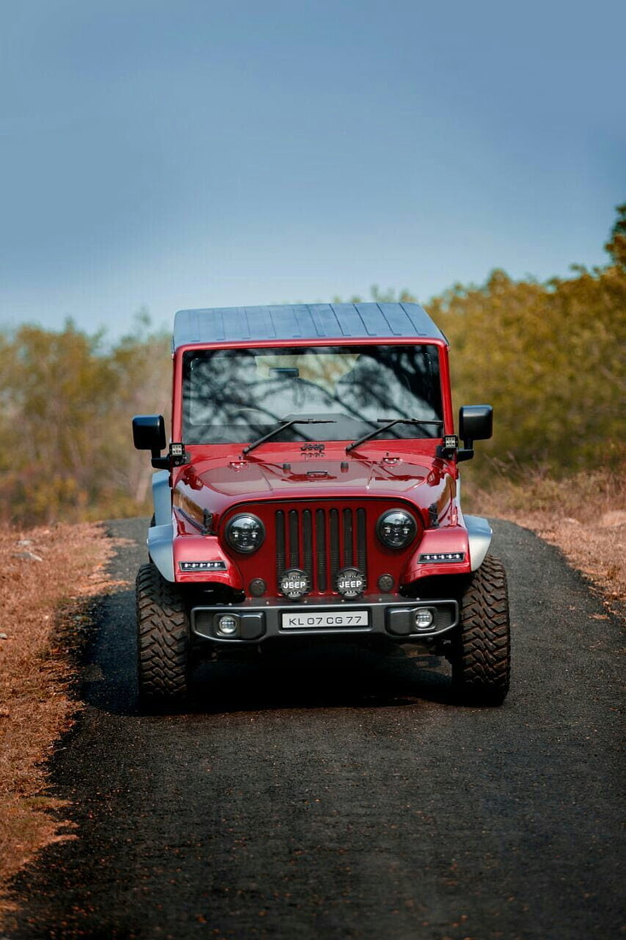 Red Mahindra Thar CRDi Modified Jeep Style SUV on a Gravel Road HD phone wallpaper