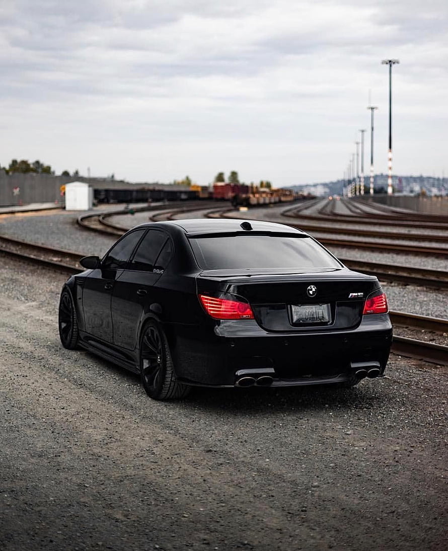 Black BMW M5 E60 Sedan Parked on Gravel Near Curved Train Tracks HD phone wallpaper