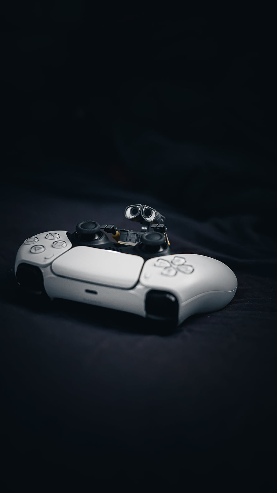 PlayStation 5 DualSense Controller with Wall-E Robot Figure on Dark Background HD phone wallpaper