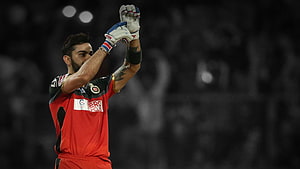 Virat Kohli in Royal Challengers Bengaluru Red Jersey Celebrating with Gloves Raised HD wallpaper