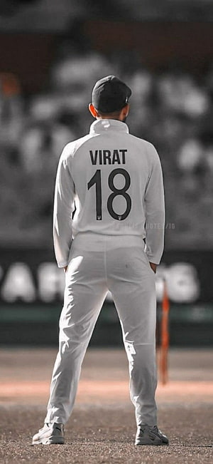 Virat Kohli standing on cricket field wearing white jersey with number 18 HD phone wallpaper