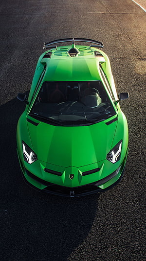 Top-down view of a vibrant green Lamborghini Aventador SVJ on asphalt HD phone wallpaper