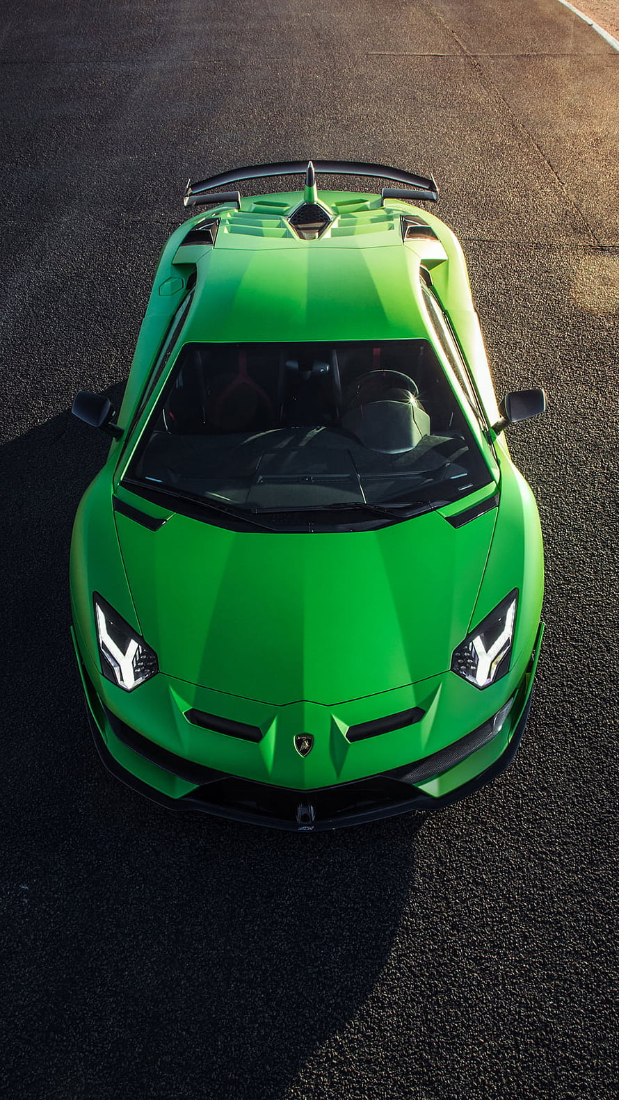 Top-down view of a vibrant green Lamborghini Aventador SVJ on asphalt HD phone wallpaper