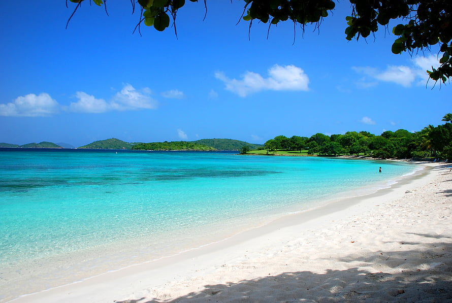 Turquoise Lagoon and White Sand Beach Framed by Tropical Foliage HD wallpaper