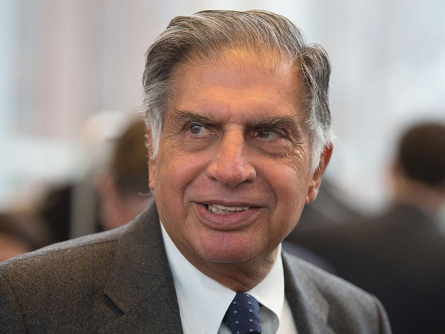 Ratan Tata in a formal grey suit and patterned tie at a professional event HD wallpaper