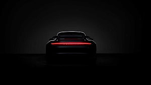 Porsche Taycan rear view with illuminated light bar in dark studio HD wallpaper