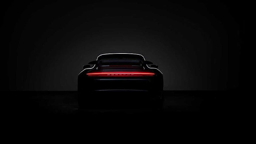 Porsche Taycan rear view with illuminated light bar in dark studio HD wallpaper