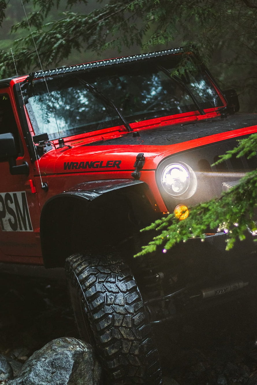 Red Jeep Wrangler Off-Road Adventure in Dense Forest Terrain HD phone wallpaper