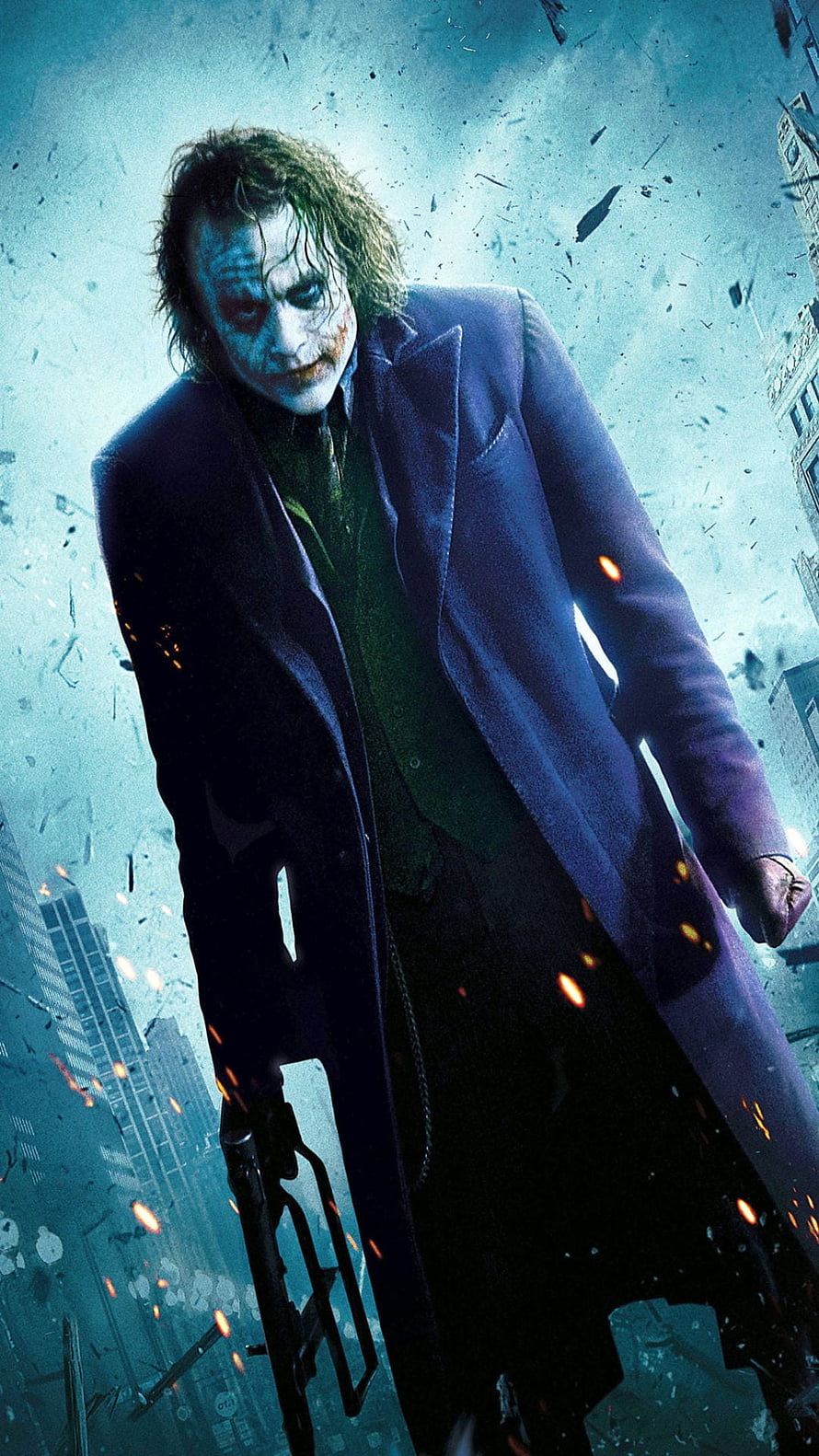 The Joker from The Dark Knight standing in a destroyed cityscape with debris and embers HD phone wallpaper