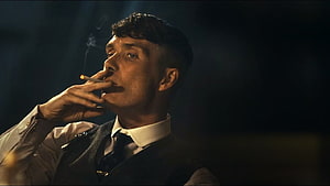 Cillian Murphy as Thomas Shelby smoking a cigarette in a dark moody scene from Peaky Blinders HD wallpaper