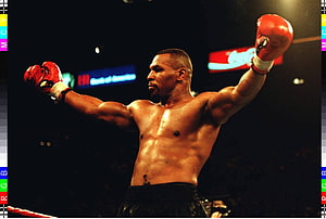 Mike Tyson in the Ring with Red Gloves and Arms Raised in Victory HD wallpaper