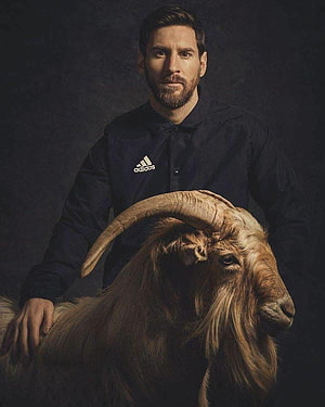 Lionel Messi Portrait with Long-Horned Goat in Dark Studio Setting HD phone wallpaper