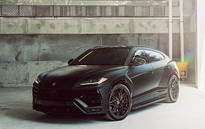 Matte Black Lamborghini Urus SUV in Industrial Concrete Garage Setting HD wallpaper
