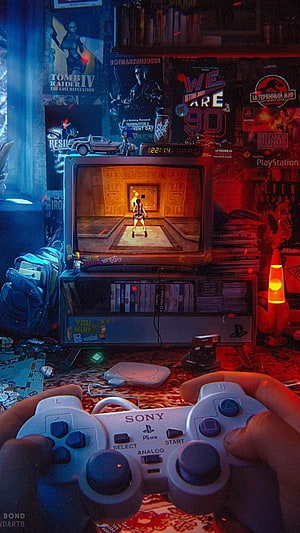 First-Person View of Hands Holding a Sony PlayStation Controller Playing a Retro Game on a CRT TV HD phone wallpaper