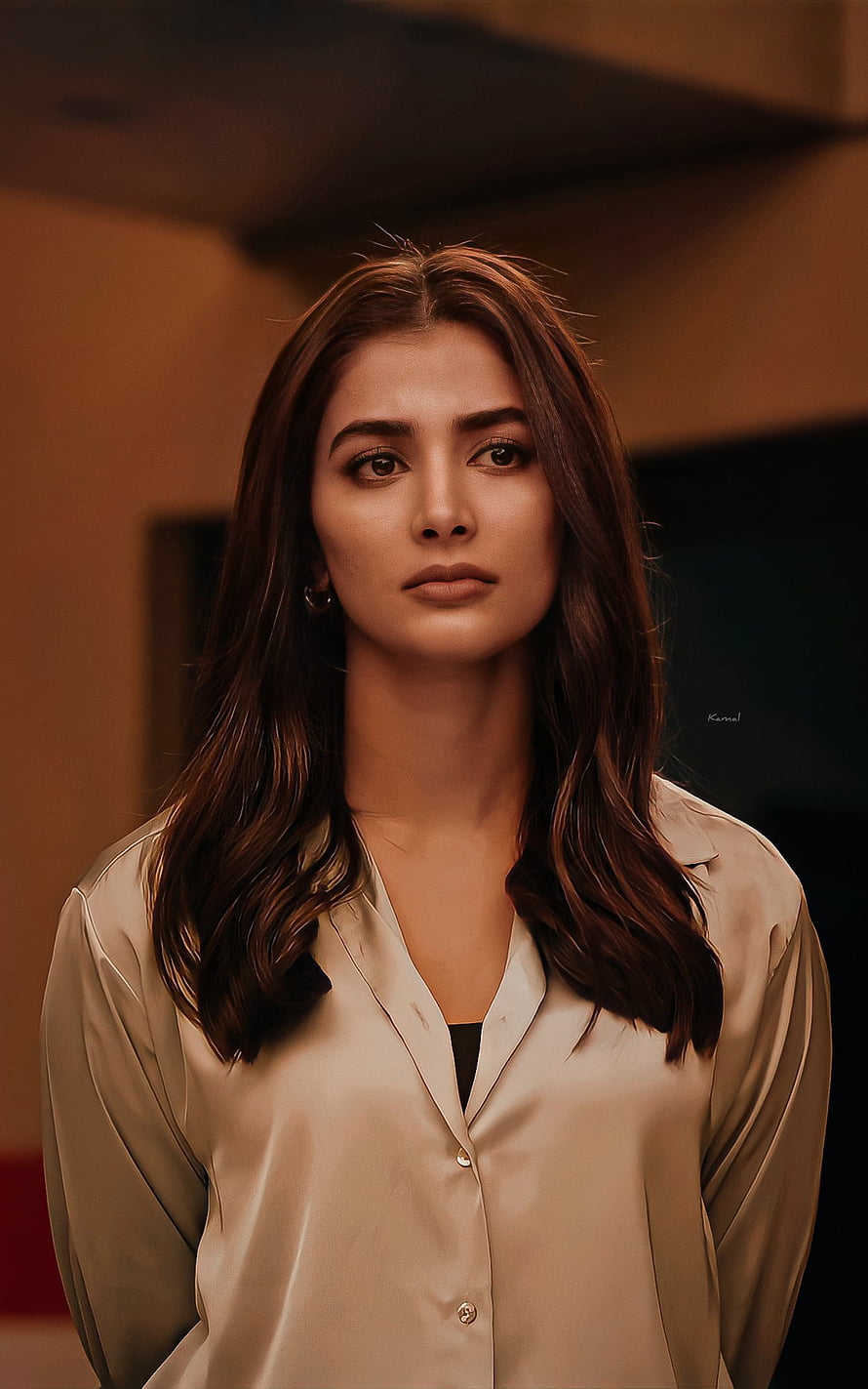 Pooja Hegde in a beige silk shirt with long wavy brown hair and a serious expression HD phone wallpaper
