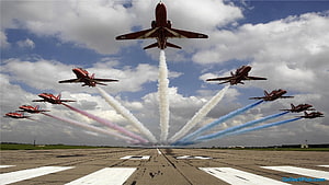 Indian Air Force jets performing a synchronized smoke trail display over an airfield runway HD wallpaper