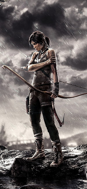 Lara Croft from Tomb Raider standing on wet rocks in heavy rain holding a recurve bow HD phone wallpaper