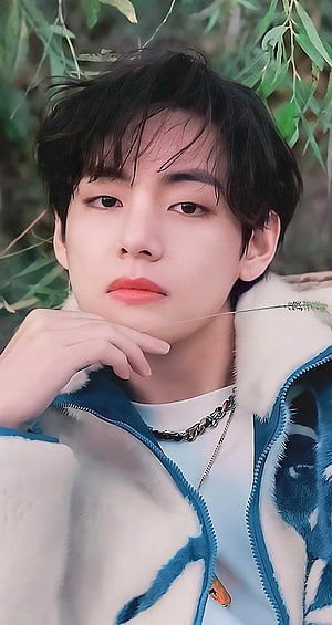 Kim Taehyung BTS Portrait in Blue and White Fleece Jacket with Green Foliage Background HD phone wallpaper
