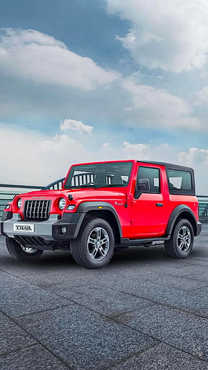 Red Mahindra Thar SUV Parked on Paved Surface Under Cloudy Sky HD phone wallpaper