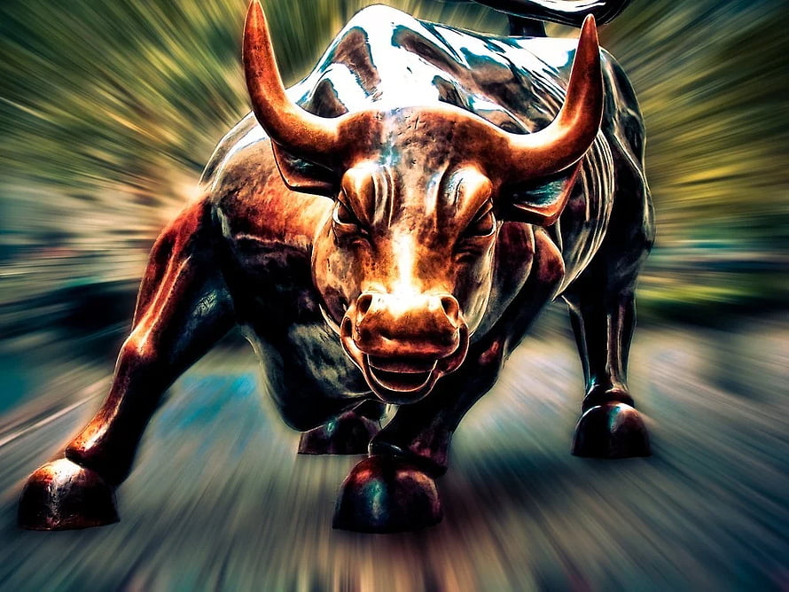Dynamic Bronze Bull Statue Charging Forward With Dramatic Motion Blur Background HD wallpaper