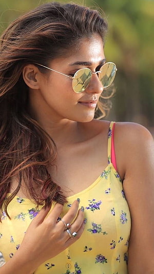 Leah Dizon wearing a yellow floral top and sunglasses HD phone wallpaper