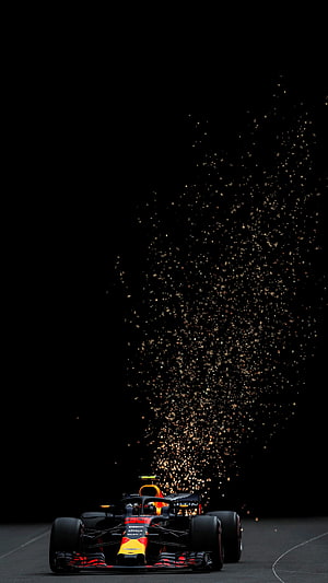 Red Bull Racing Formula 1 car with dramatic sparks on a dark track HD phone wallpaper